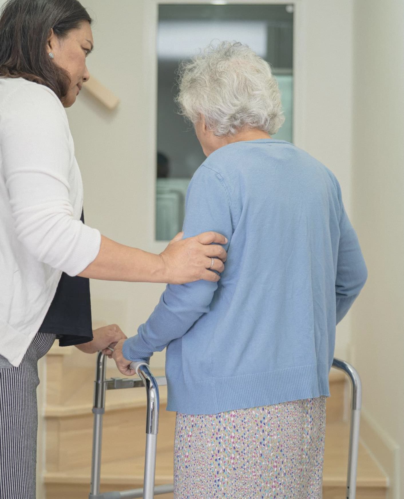Caregiver assisting elderly woman with medication and health support