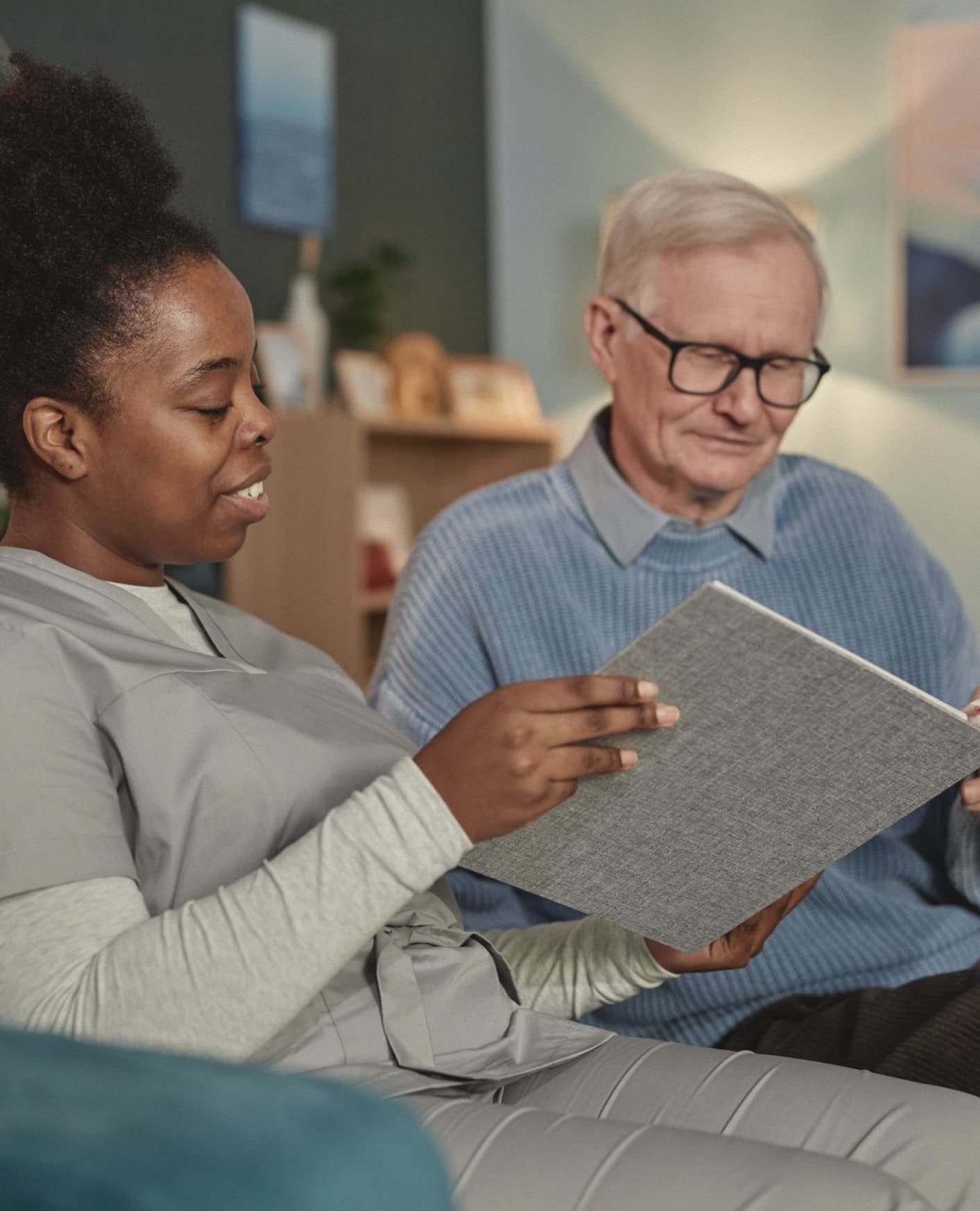 Professional caregiver managing care plan on laptop in home setting