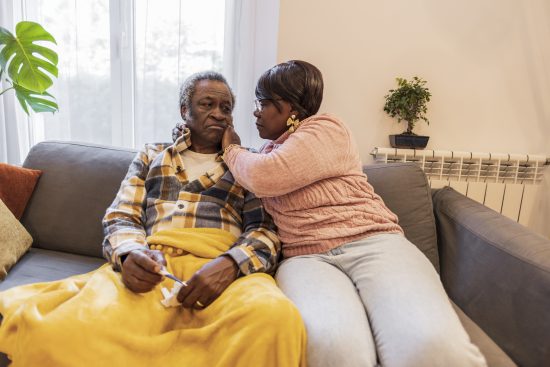 senior couple, sick man, his wife takes care of him