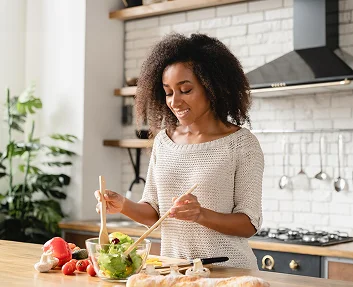 Woman preparing a fresh salad in a kitchen