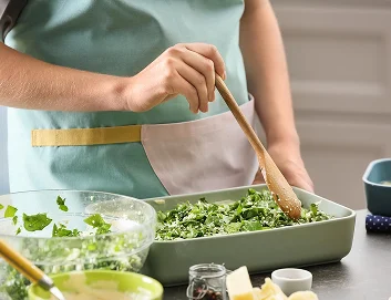 Caregiver preparing healthy meal in kitchen