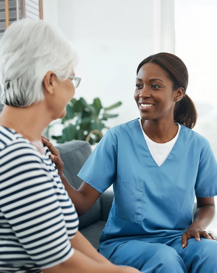 Caregiver talking with an elderly woman at home