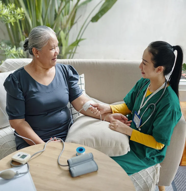 Nurse providing bedside care to a senior patient