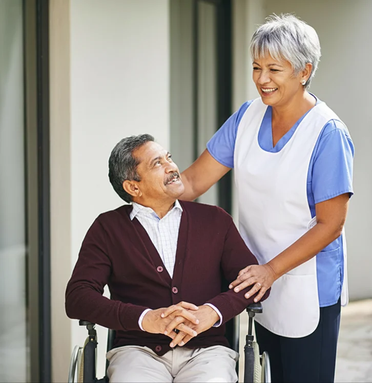 Caregiver assisting a man in a wheelchair