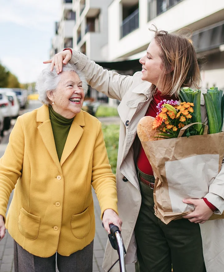 Caregiver talking with a smiling senior woman