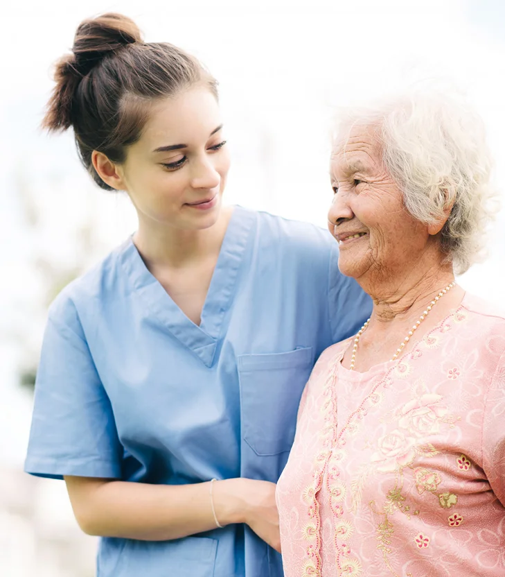 Caregiver supporting an elderly woman