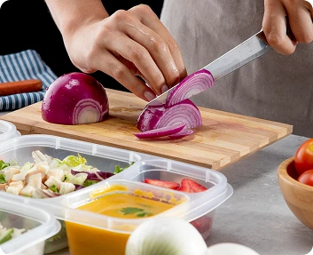 Claude responded: Caregiver slicing a red onion while preparing healthy meals in the kitchenCaregiver slicing a red onion while preparing healthy meals in the kitchen