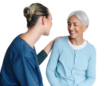 Caregiver talking with a smiling senior woman