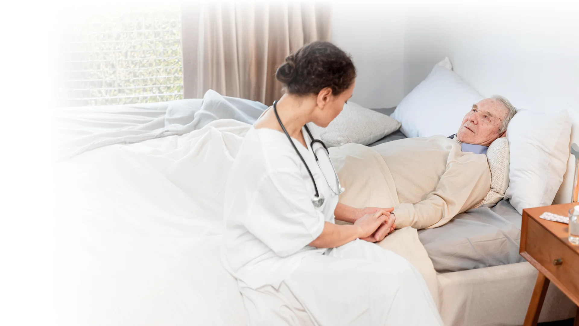 Nurse providing compassionate bedside care to a senior patient