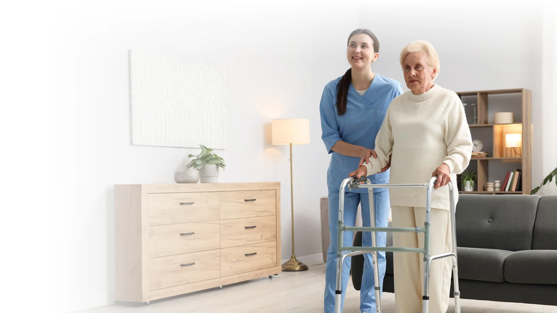 Caregiver assisting a senior woman walking with a walker