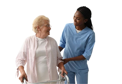 Caregiver in blue scrubs assisting a senior woman walking with a walker