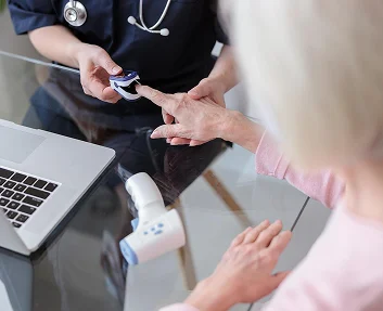 Nurse checking a senior patient's blood oxygen level