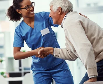 Caregiver holding hands with a senior woman