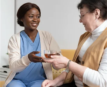 Caregiver serving tea to a senior woman