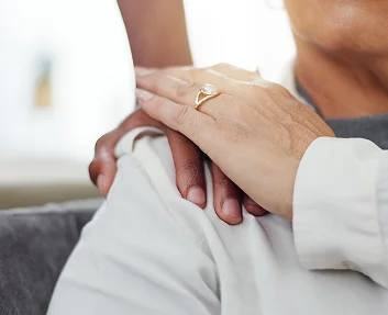 Caregiver holding a senior patient's hand