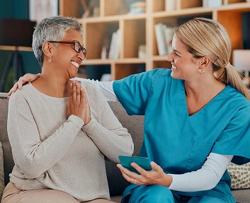 Caregiver talking with a smiling senior woman
