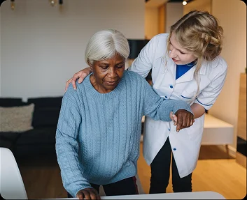 Caregiver assisting a senior woman with mobility