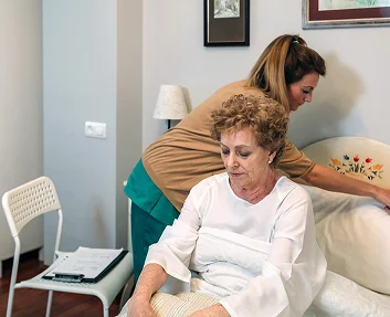 Caregiver reviewing medications with a senior patient