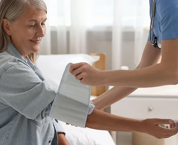 Nurse measuring a senior patient's blood pressure