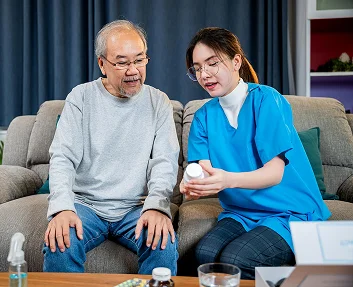 Caregiver reviewing medications with a senior man