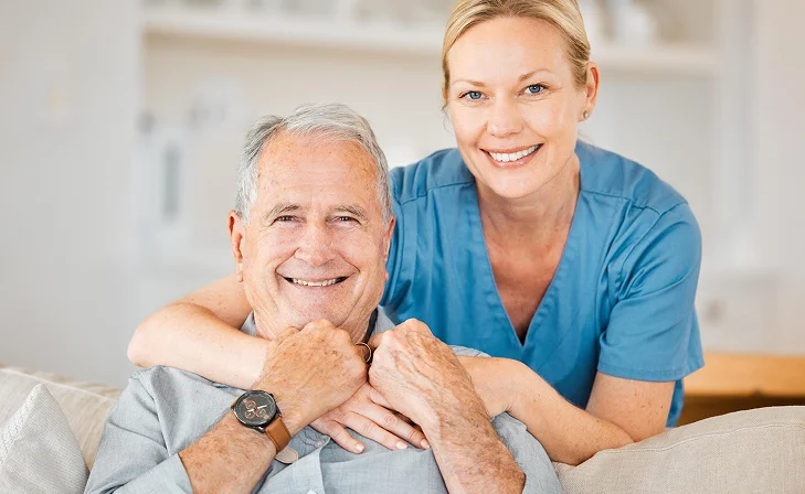 Caregiver smiling with an older man