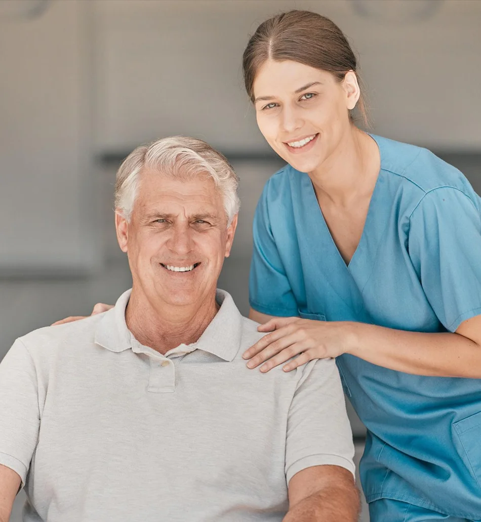 Caregiver supporting a smiling senior man
