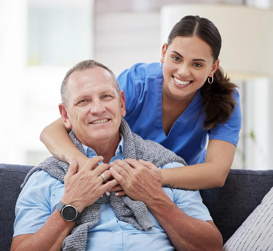 Caregiver smiling with an older man