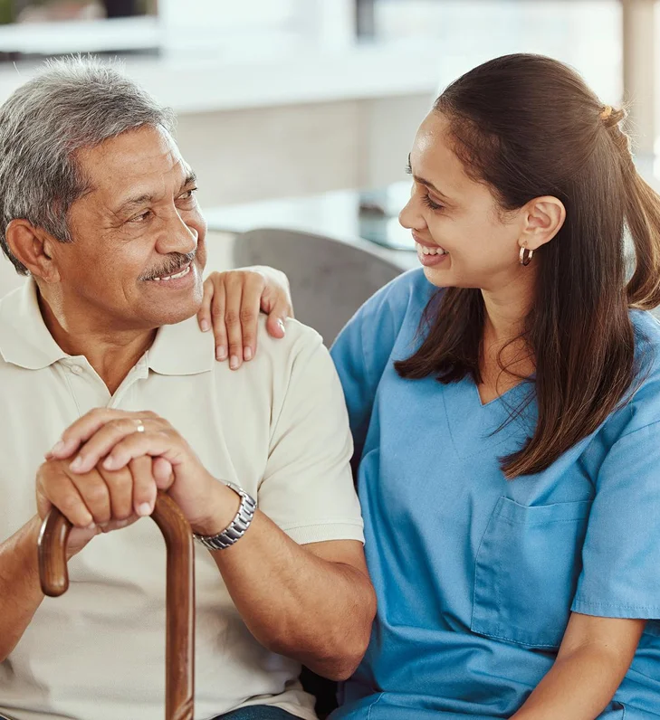 Caregiver assisting a senior man at home