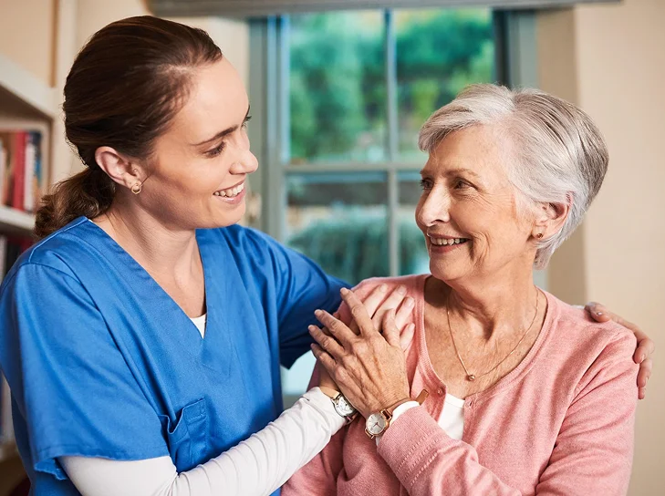 Caregiver comforting an older woman