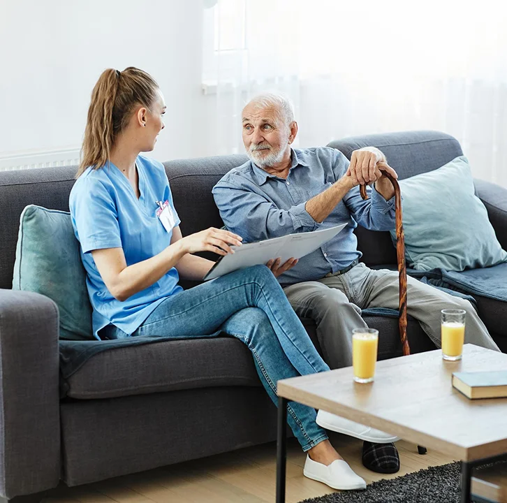 Caregiver assisting a senior man at home