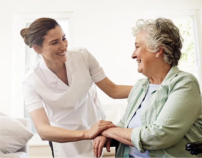 Caregiver comforting an elderly woman