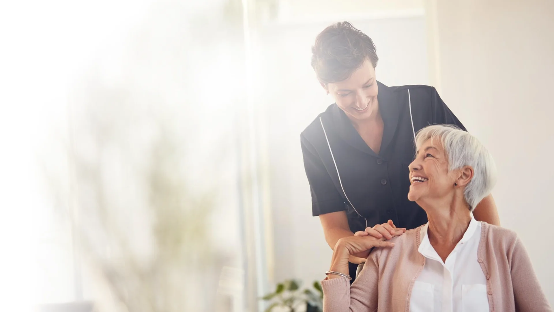 Caregiver spending time with a senior woman