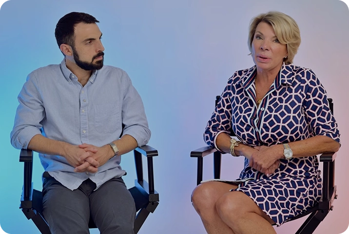 Man and woman seated in director chairs during an interview
