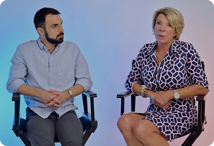 Man and woman seated in director chairs during an interview
