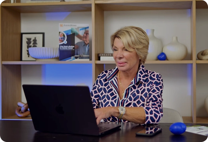 Woman working on a laptop at an office desk