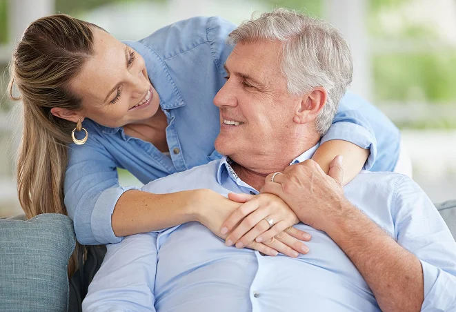 Woman embracing senior man