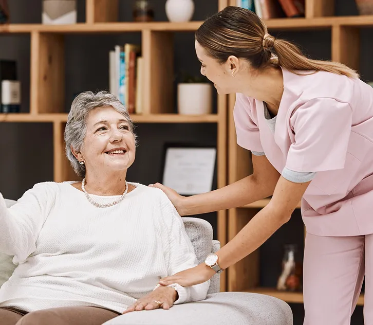 Caregiver comforting a senior woman at home