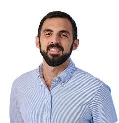 Professional man in blue striped shirt smiling at camera headshot