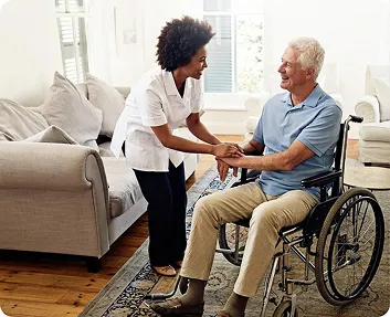 Caregiver talking with a senior man in a wheelchair