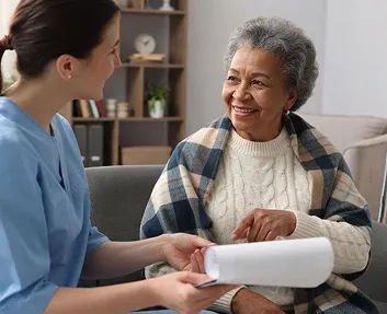 Caregiver discussing care with a senior woman at home